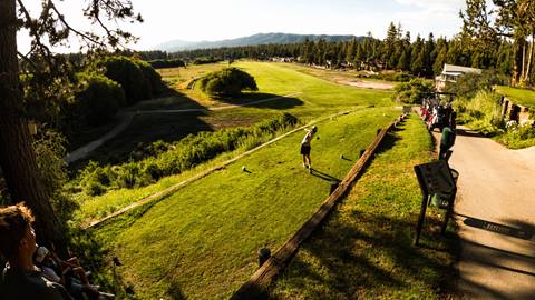 A golfer teeing off on the tee box at Bear Mountain Golf Course