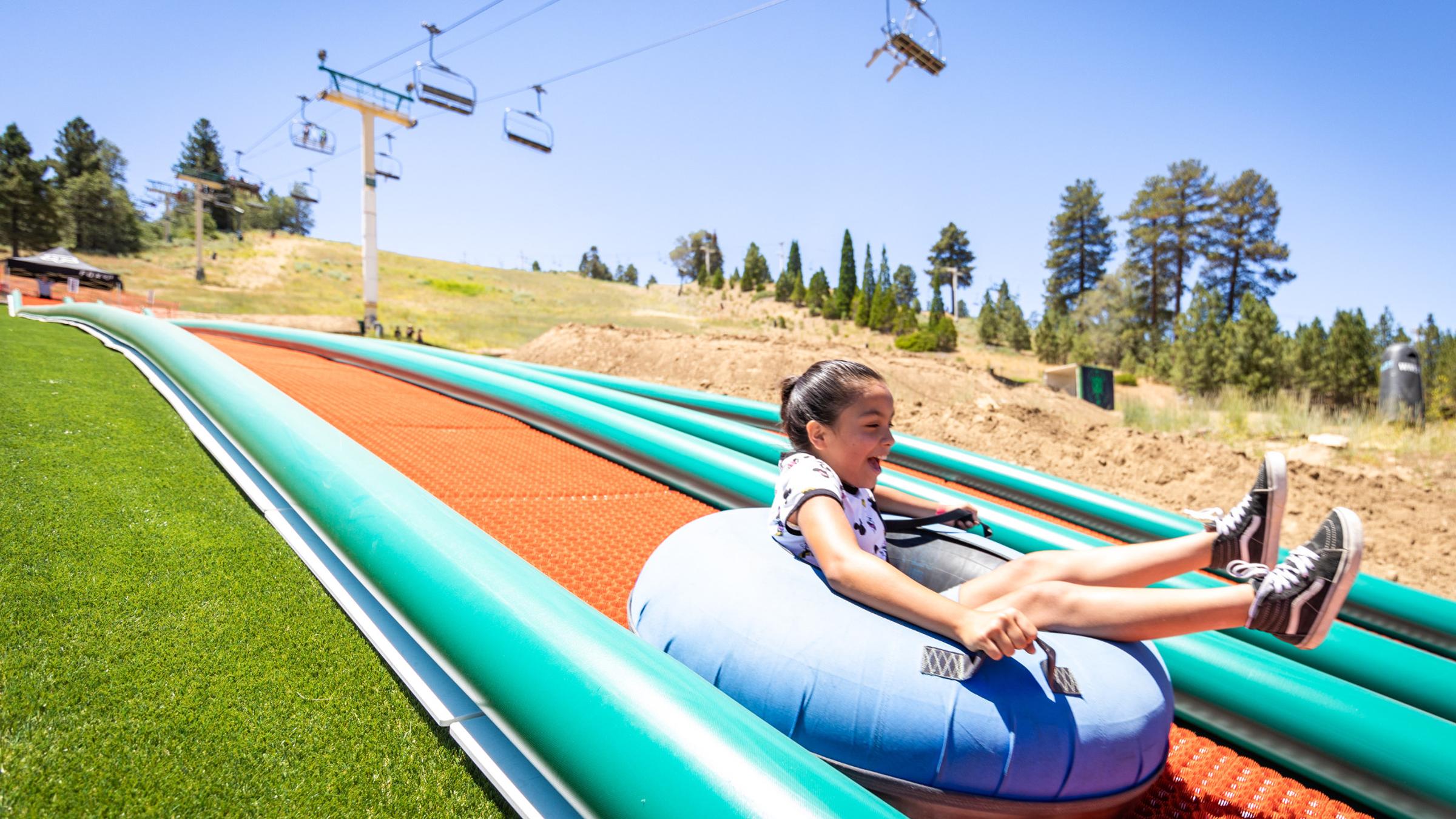 Girl going down a summer inner tube