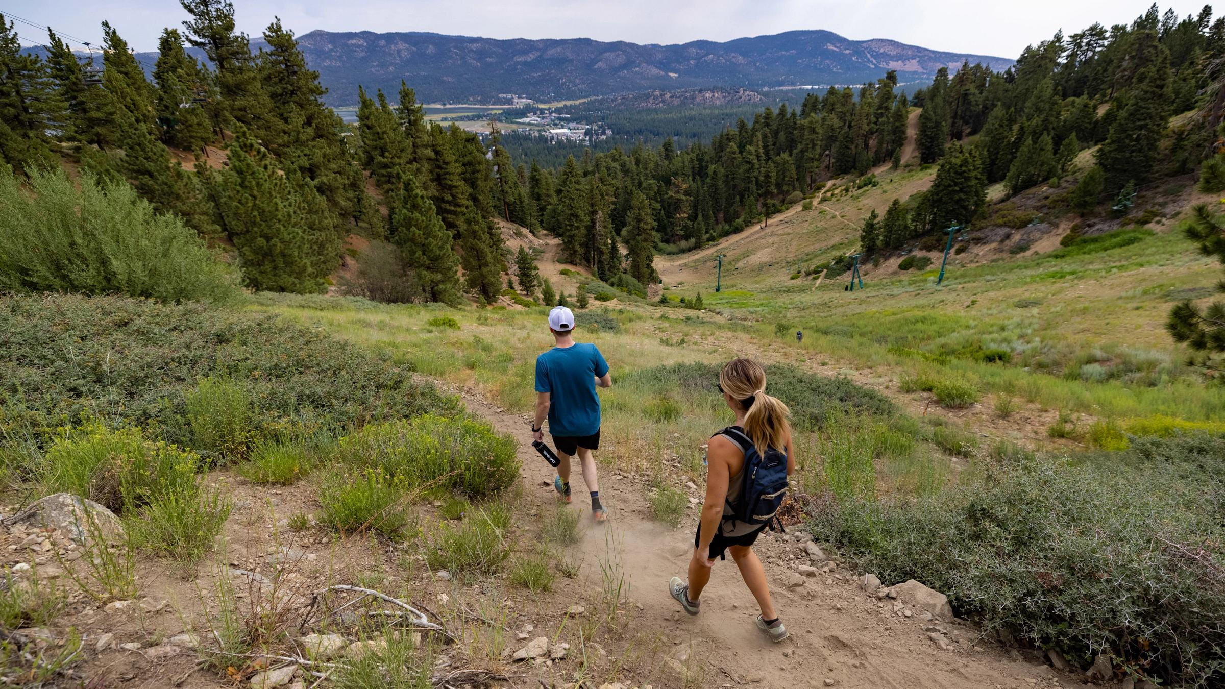 A couple hiking on a trail at Snow Summit