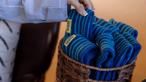 hand grabbing a basket fulled with Ikon Pass head bands in the Ikon Pass Suite at Snow Summit