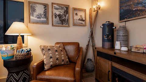 Couch, lamp, and frames on wall in the Ikon Pass Suite at Snow Summit