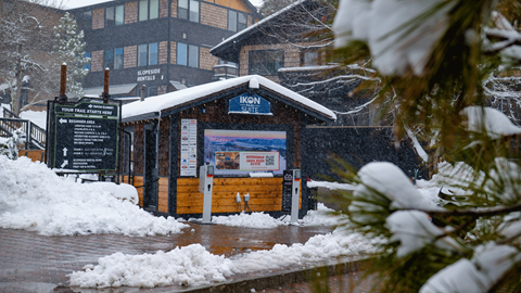 Exterior of Ikon Pass Suite building with snow in front