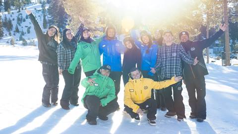 Group of employees for big bear mountain resort standing in the snow posing for a photo