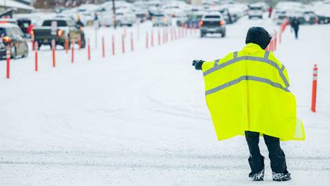 BBMR Parking Lot attendant directing cars through parking lot