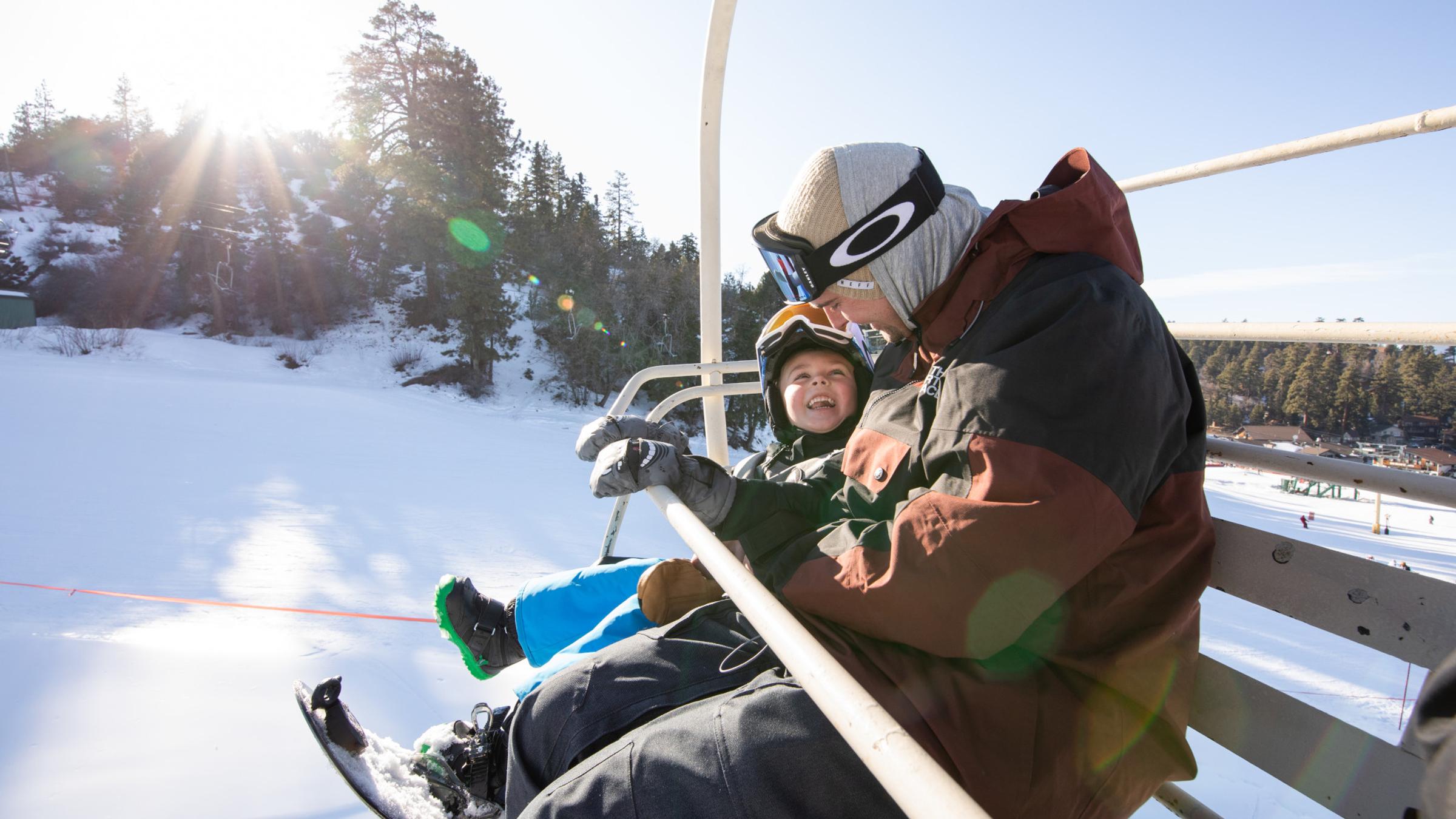 Father and son on a ski lift.