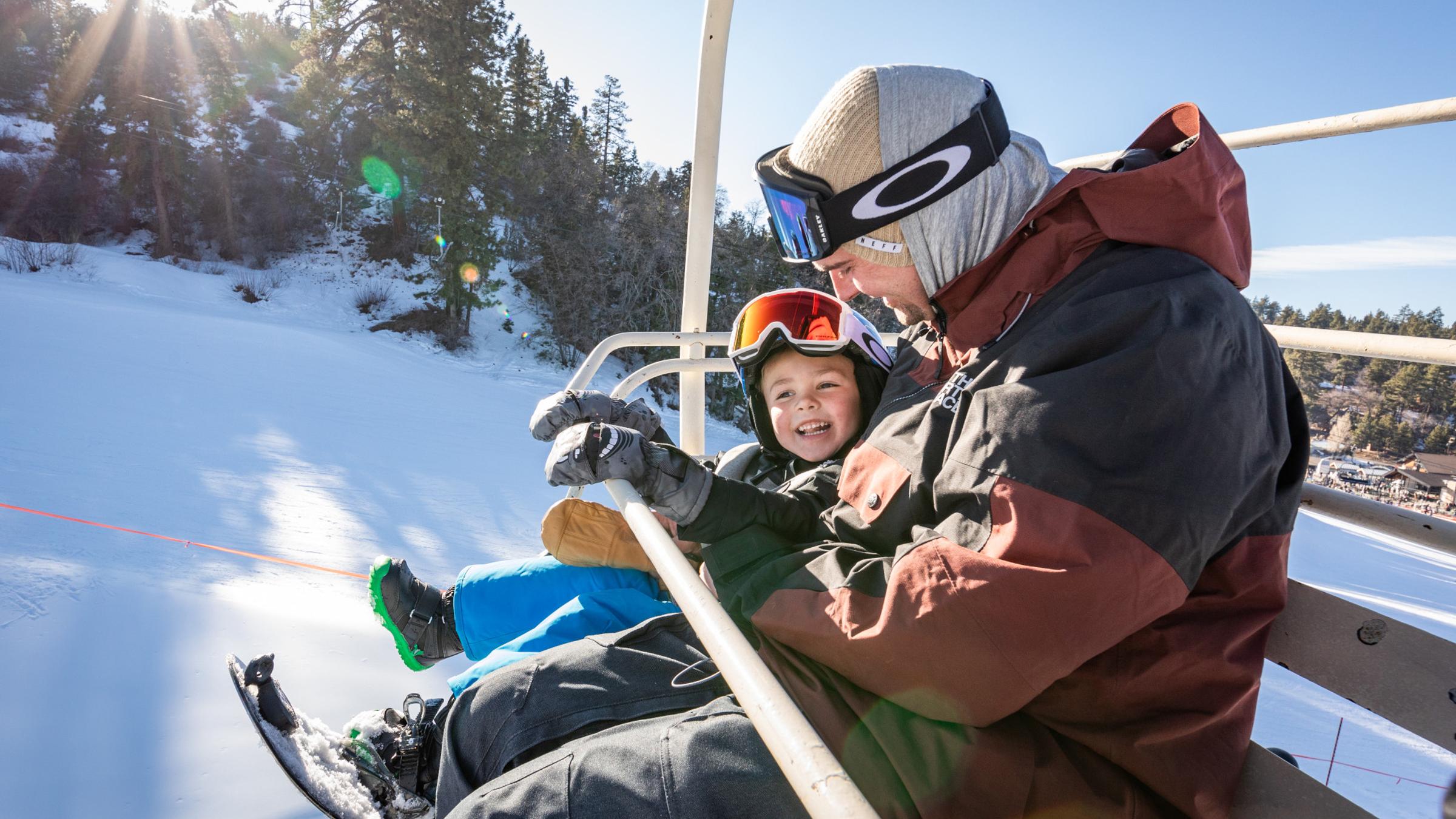 Father and son on a ski lift.