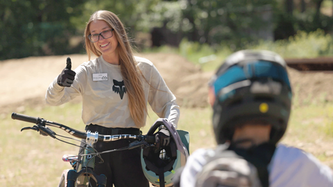 MTB instructor giving a thumbs up during a mountain biking lesson with a child at Snow Summit in the summer