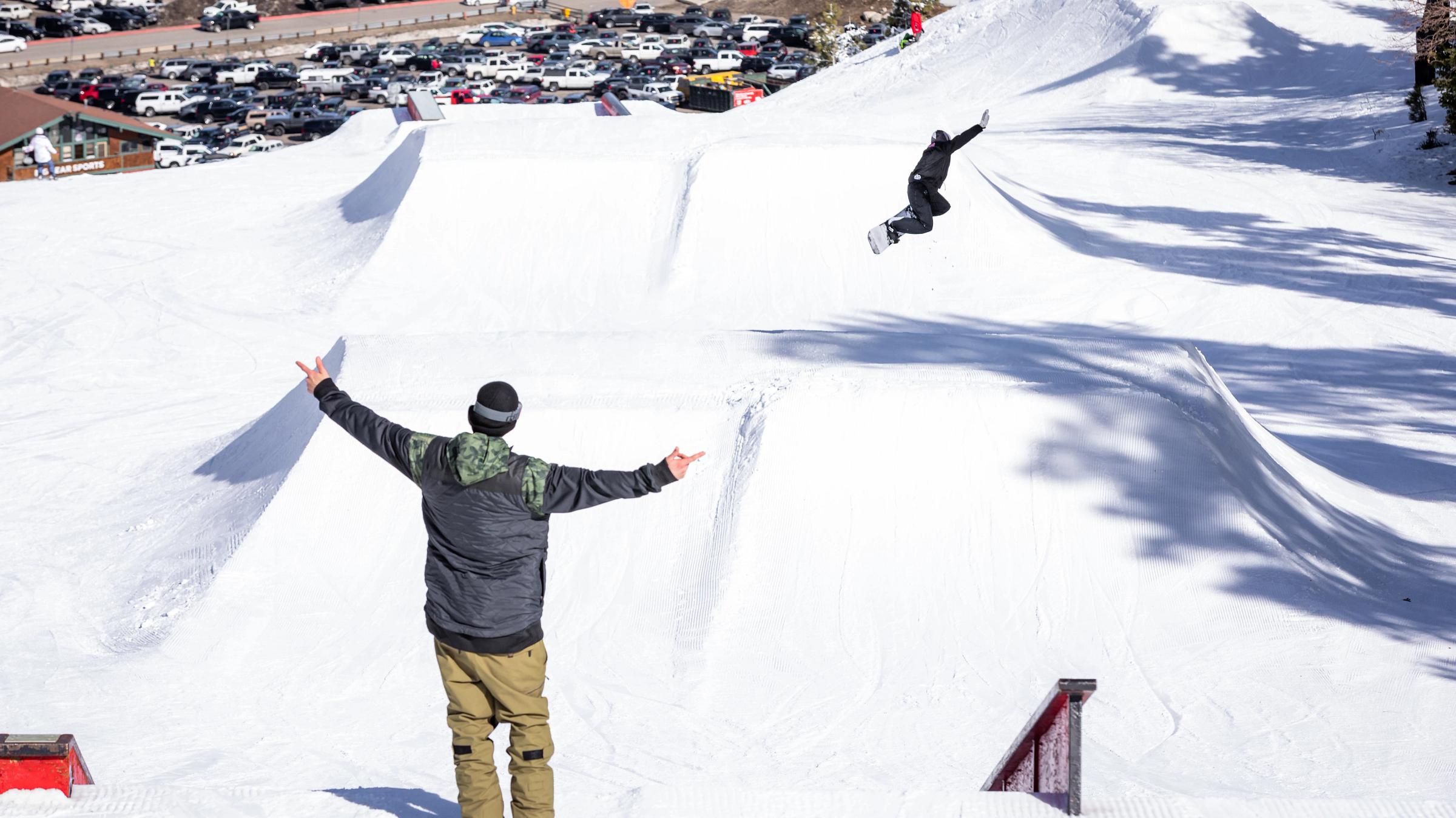 Snowboarder going down slopes