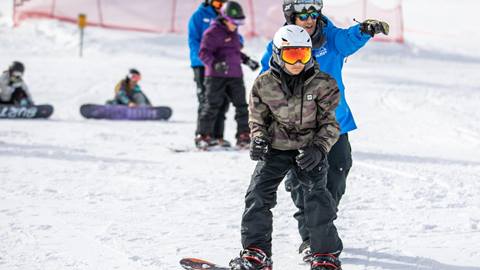 Teenager in a snowboarding lesson