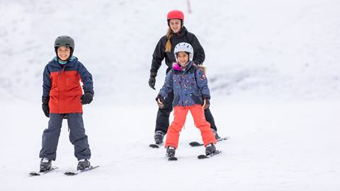 two kids taking a ski lesson