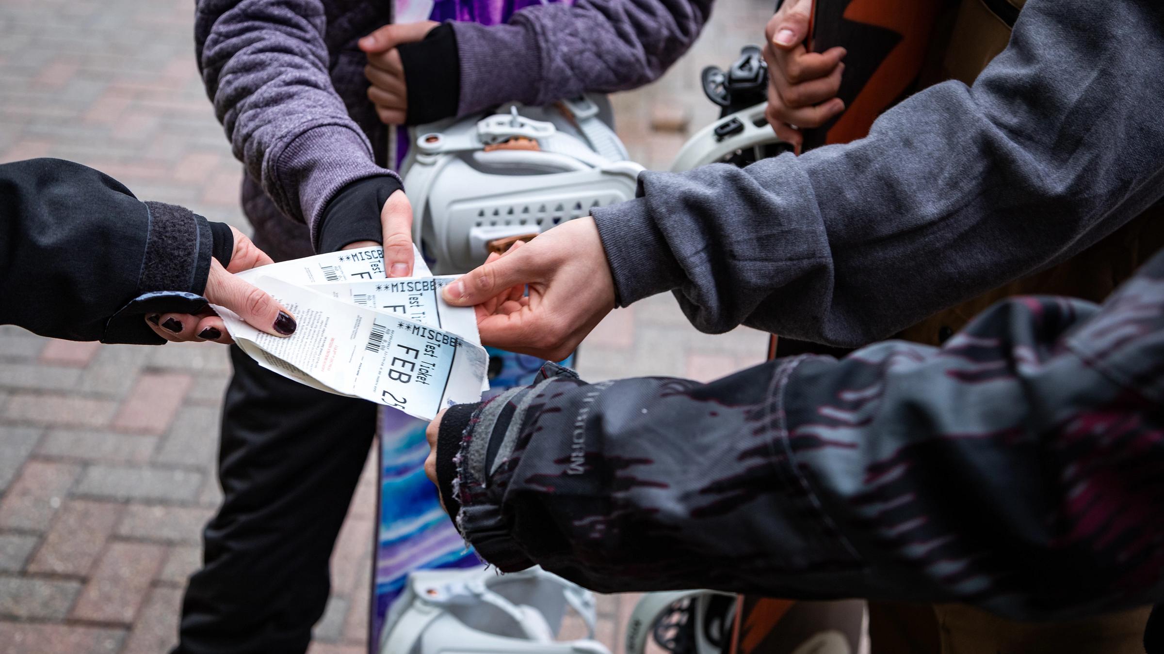 People holding lift tickets.