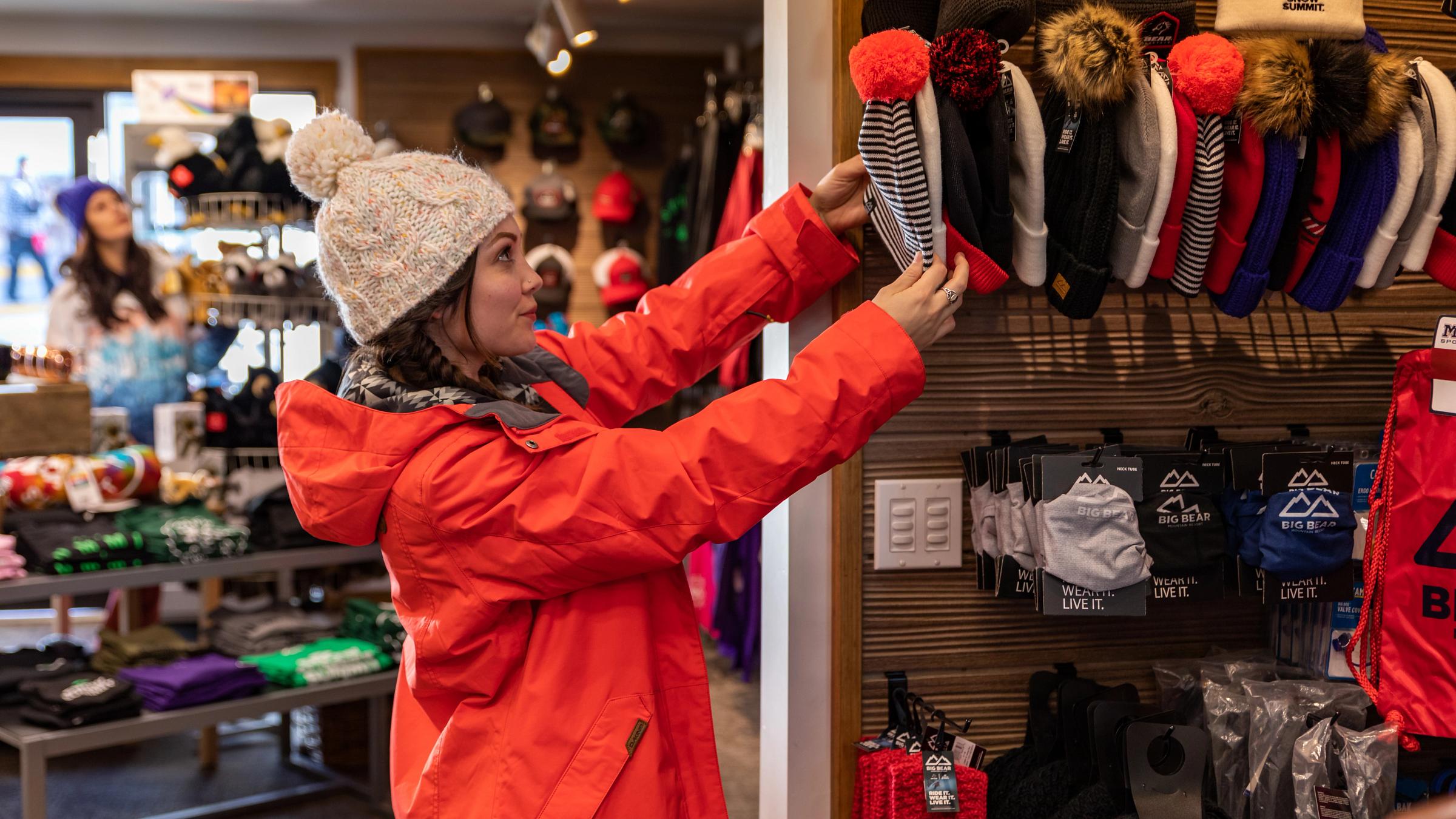 girl shopping for beanies