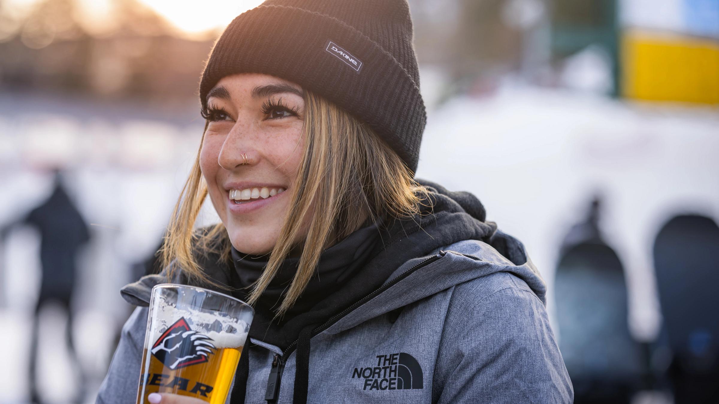 girl smiling while holding a beverage