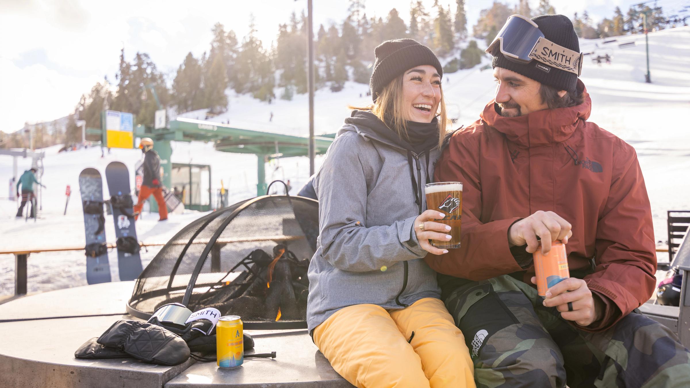 couple drinking by the fire pit