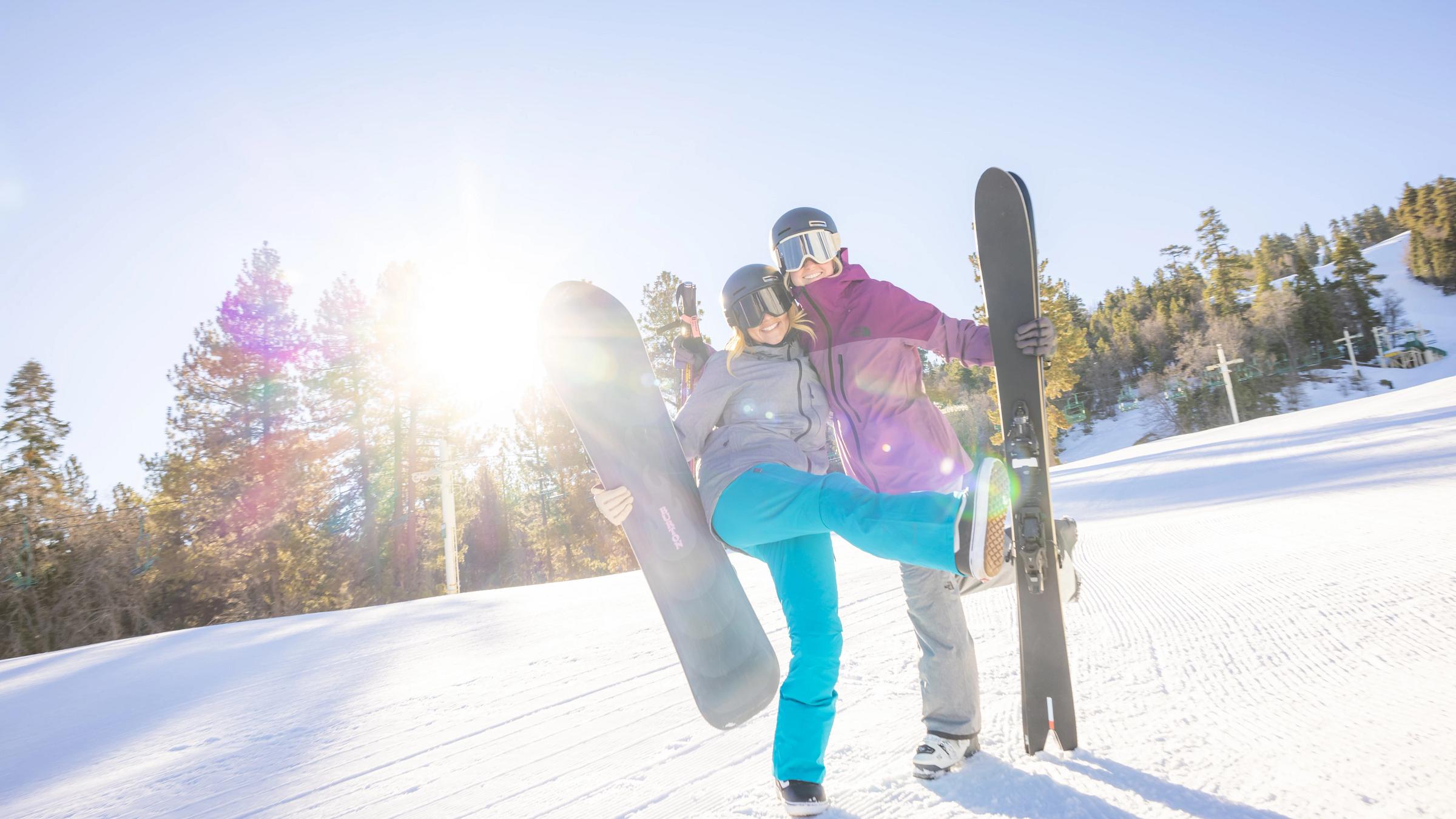 Two snowboarders smiling
