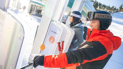 skier scanning ski pass at big bear mountain resort lift gate 