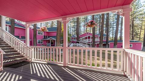 Pink building with white fence, image of deck