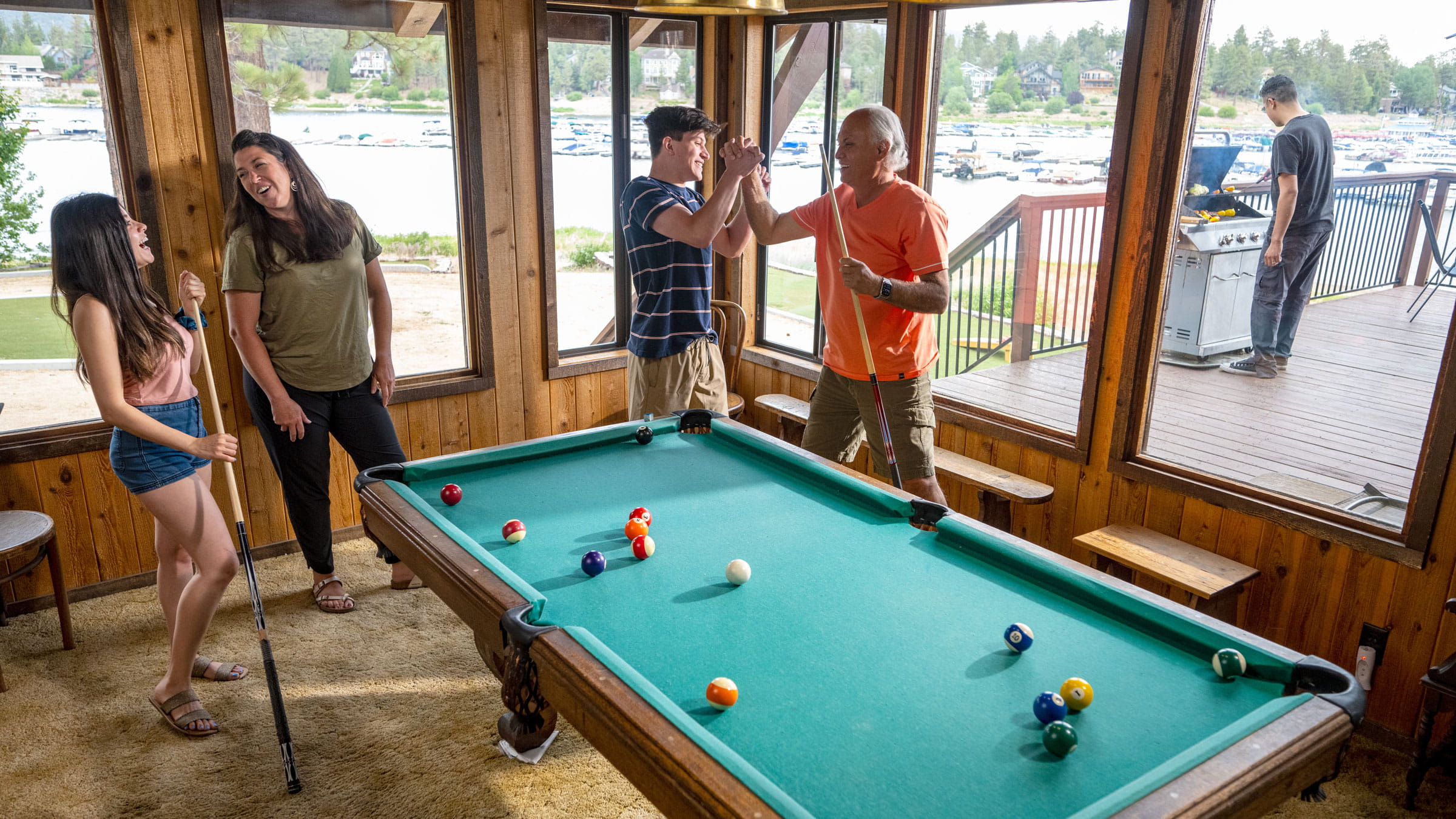 People standing around a pool table