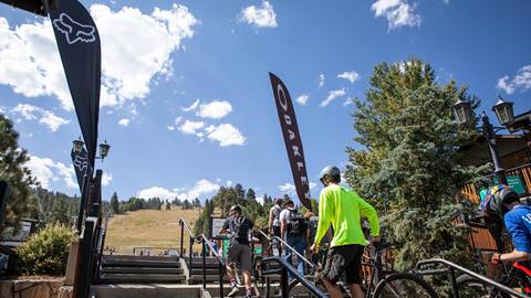 Mountain bikers walking up to the runs