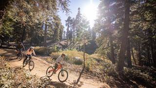 bike park season passes - three people riding bikes at snow summit bike park