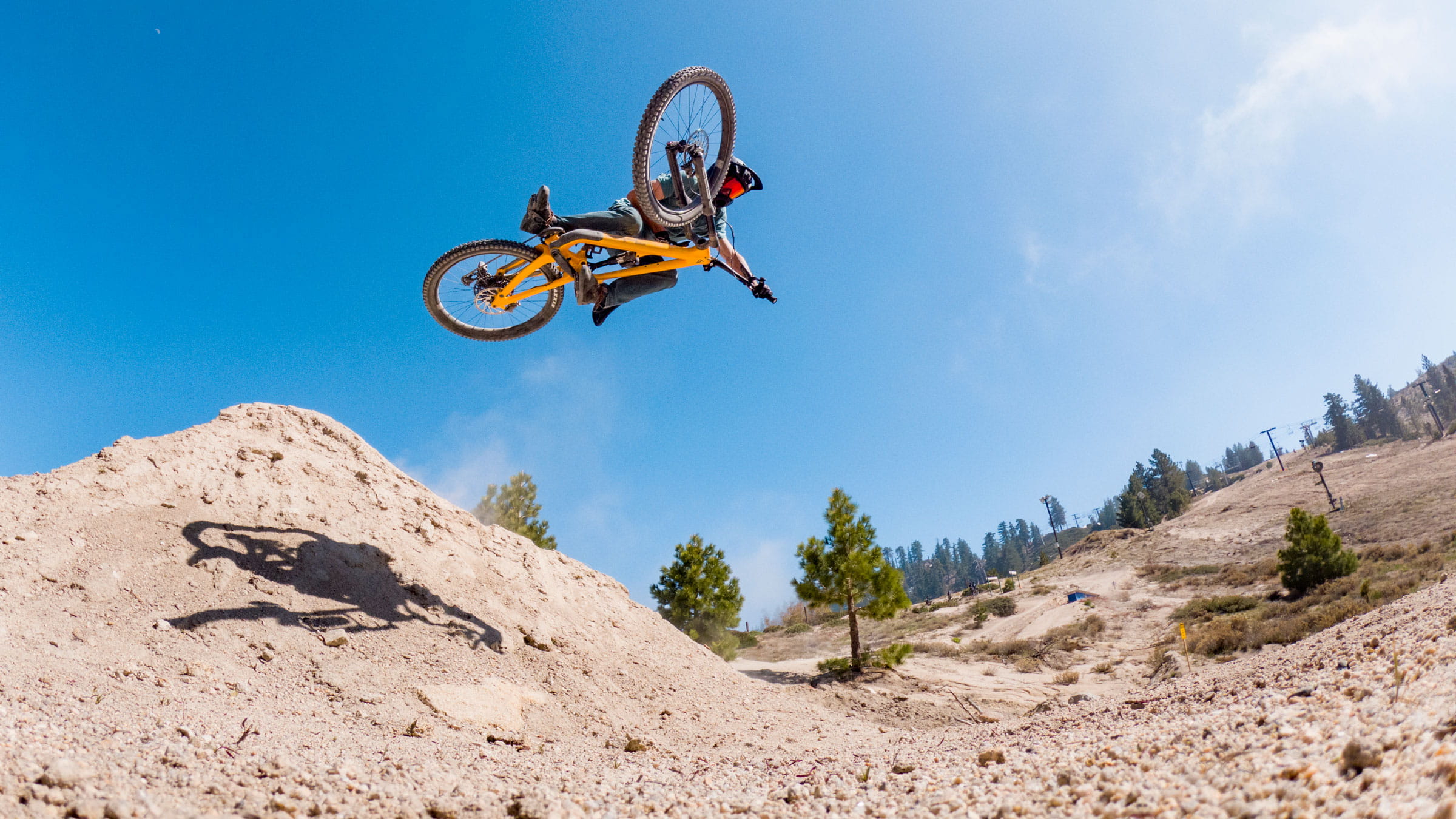 Snow Valley bike park, mountain biker on an orange bike in the air