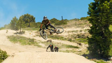 Mountain biker going doing a whip trick on their MTB at Snow Valley bike park