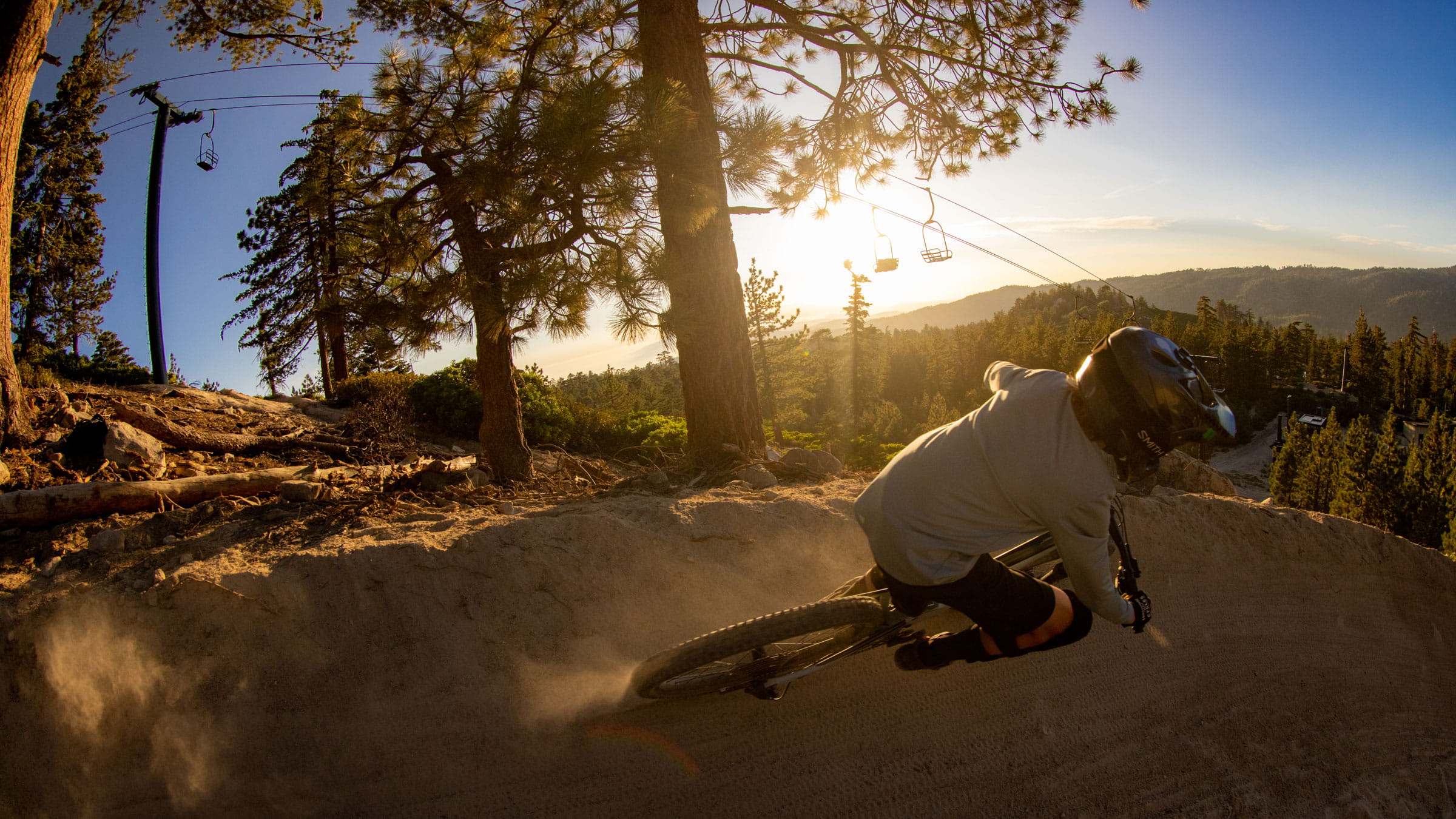 mountain biker riding downhill trails during sunset at snow valley bike park