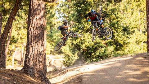 Two mountain bikers jumping
