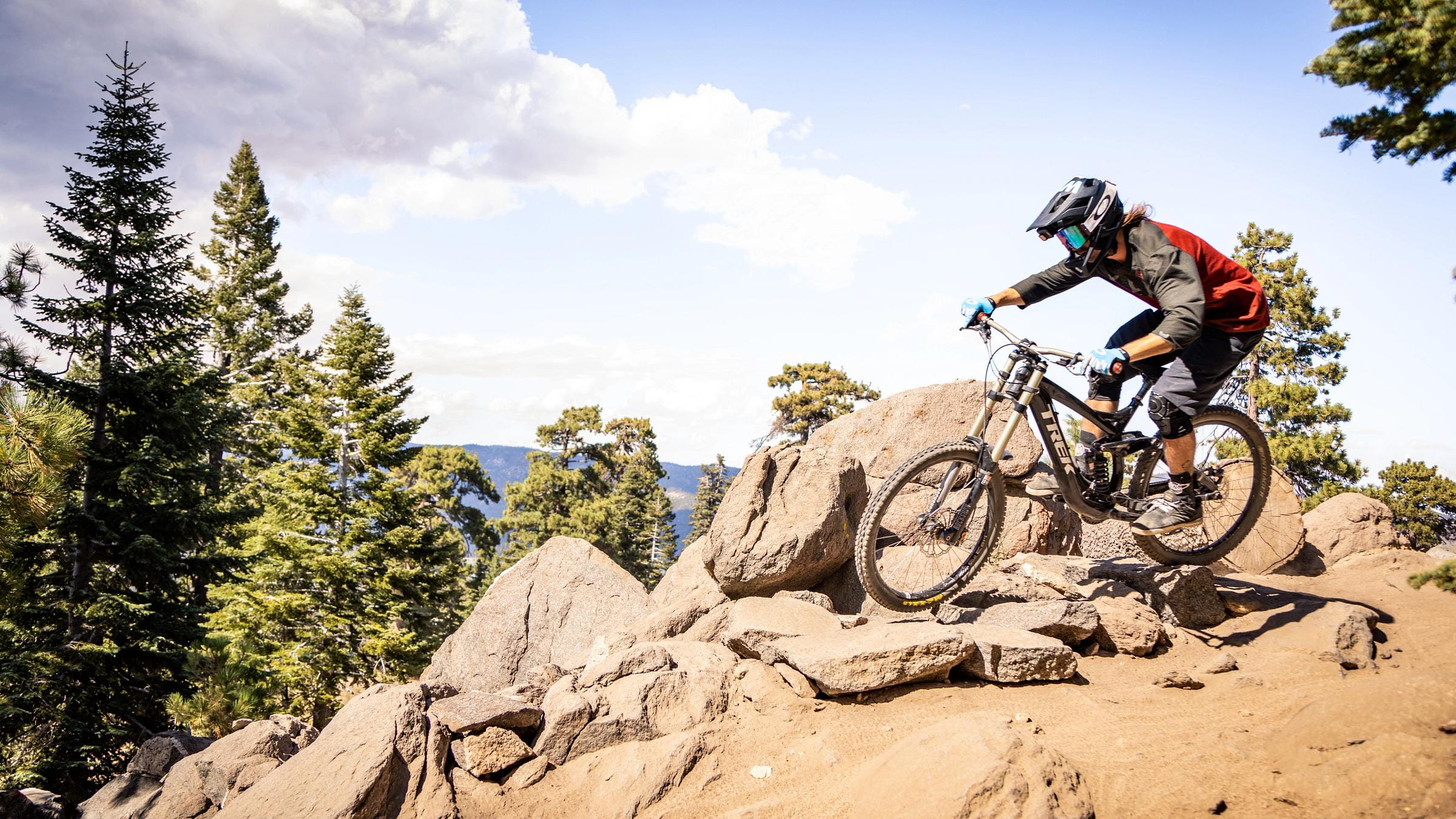 Mountain biker going down pile of large rocks.