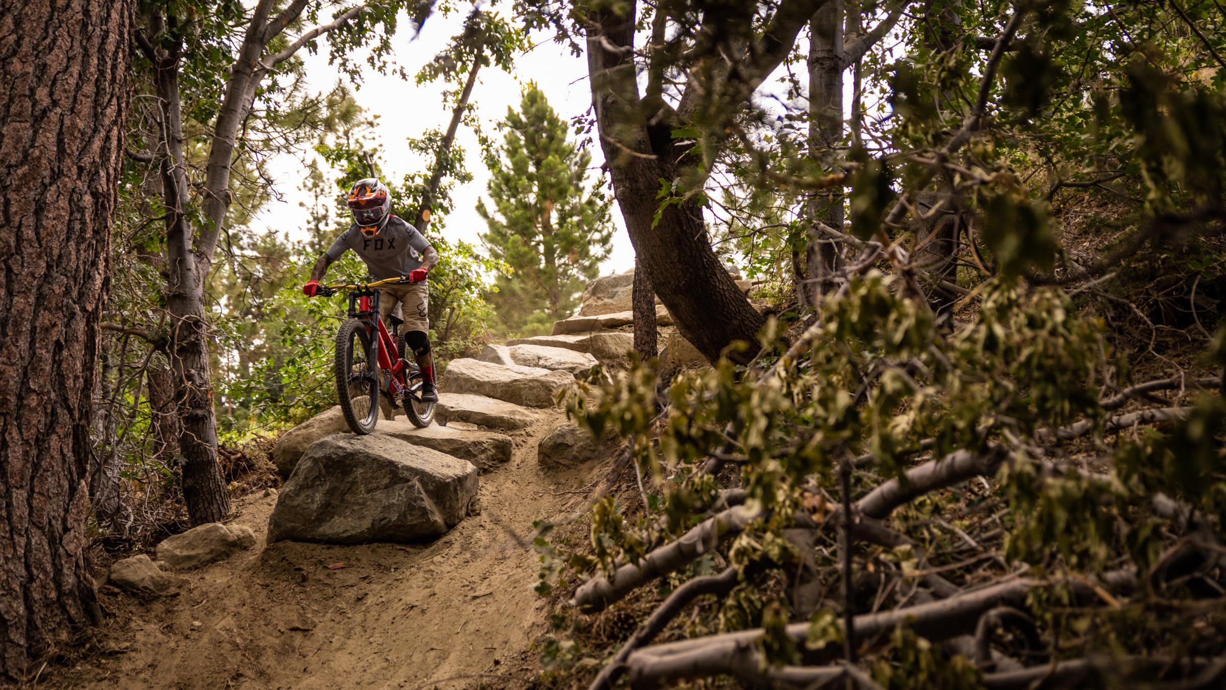 Mountain biker going down pile of large rocks.