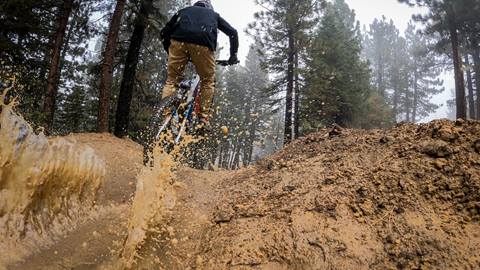 Mountain biker going thru mud