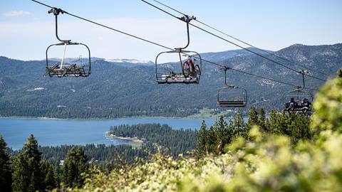 chairlifts in the summertime with mountain bikes overlooking big bear lake