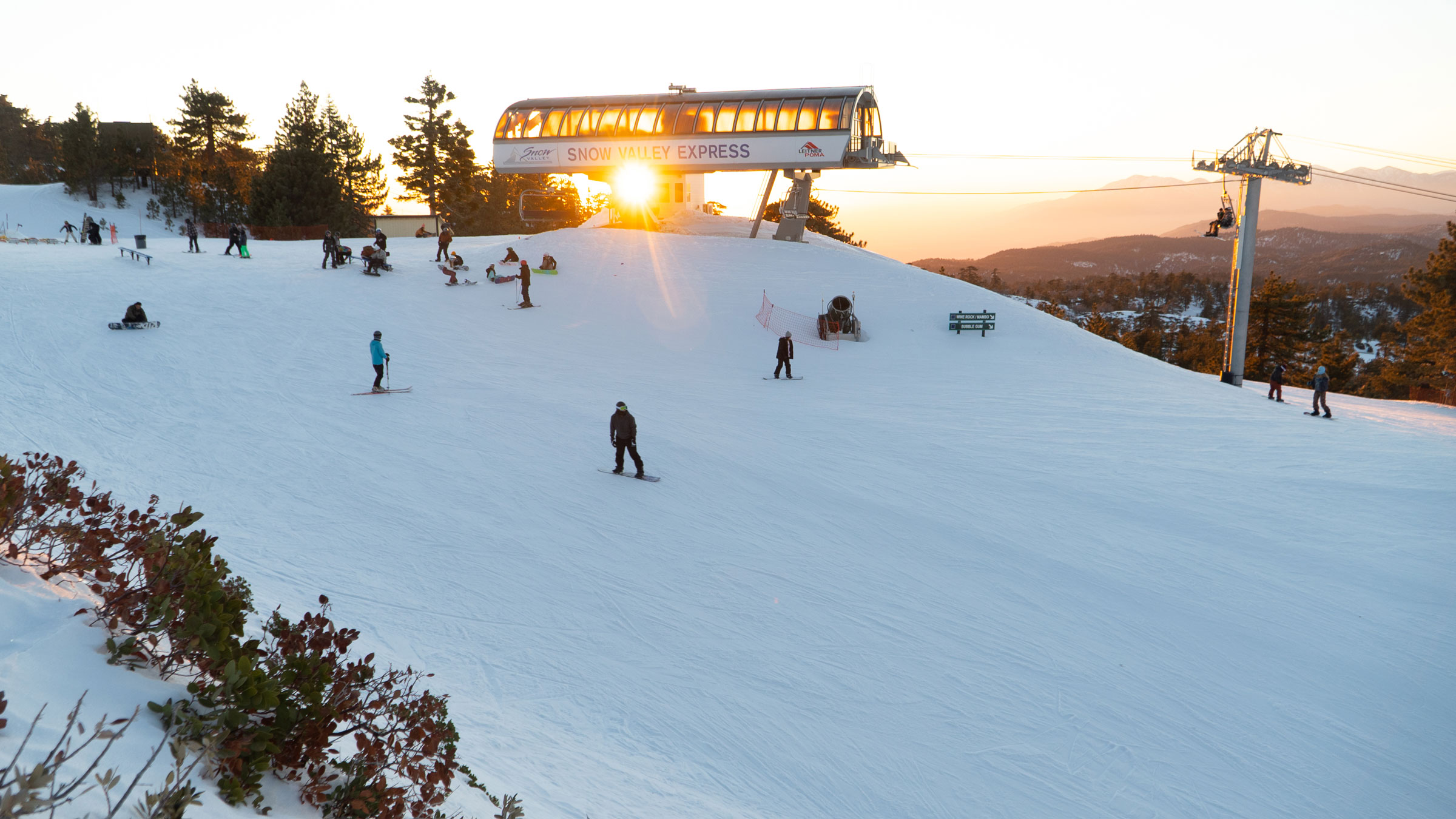 Night skiing and snowboarding at snow valley at the top