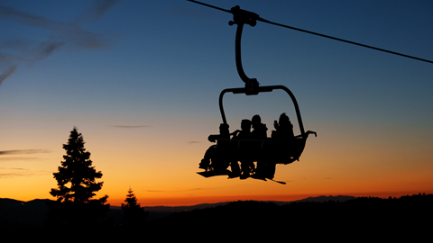 Night skiing at Big Bear Mountain Resort under illuminated ski slopes.
