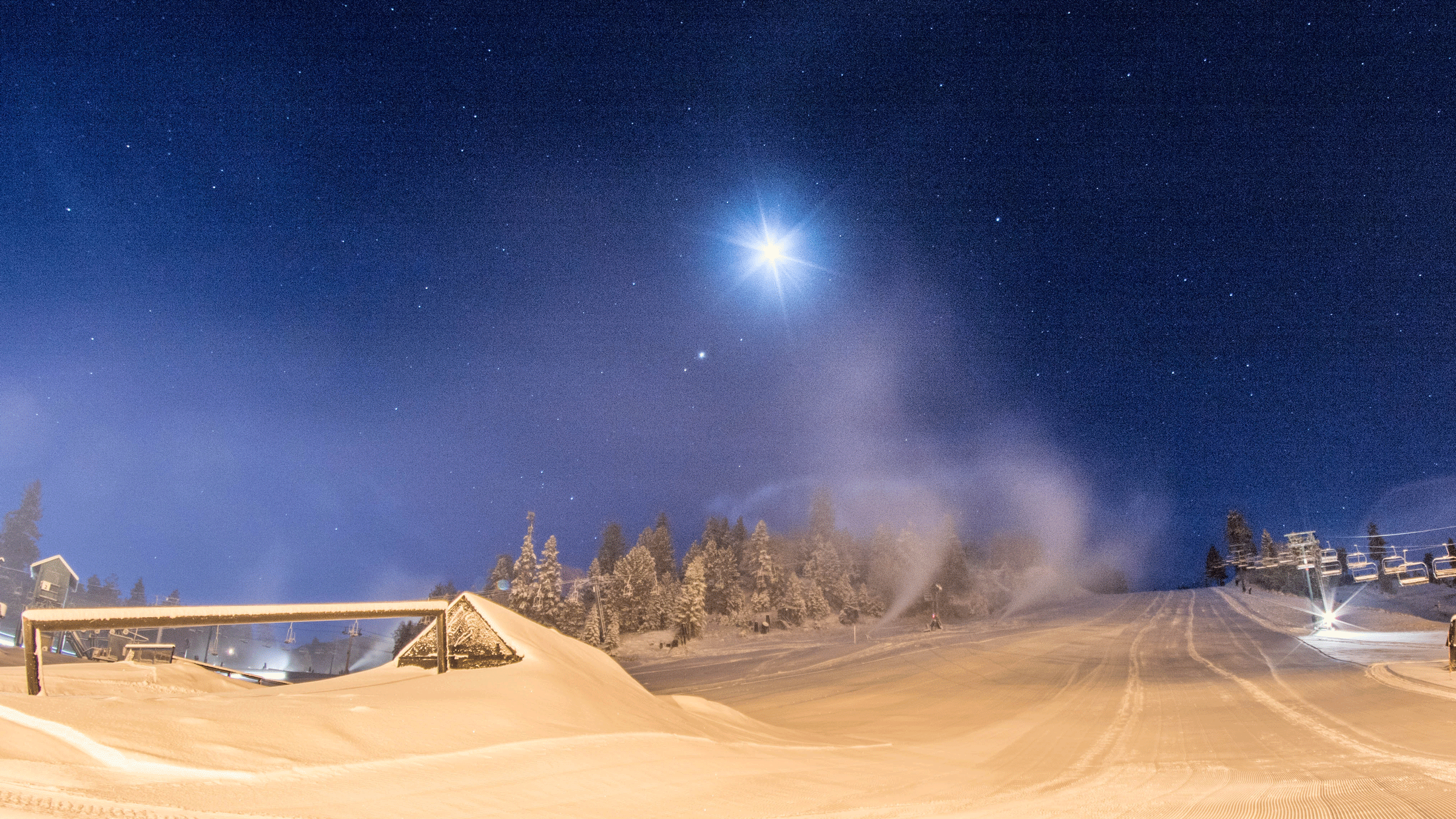 Night Session scenic shot with blue skies and the moon with snow on the ground
