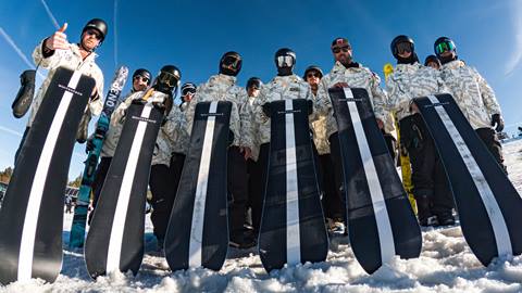 A fish eye camera lens group photo of the Team Bear coaches during a sunny winter day.