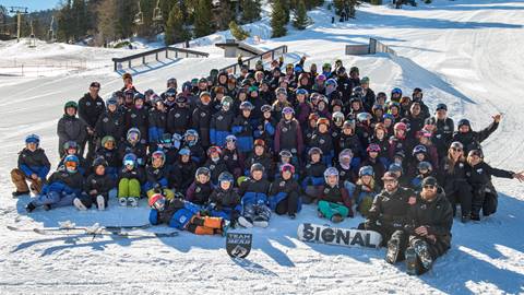 group photo shot of the team bear race team on the snow at bear mountain in the winter