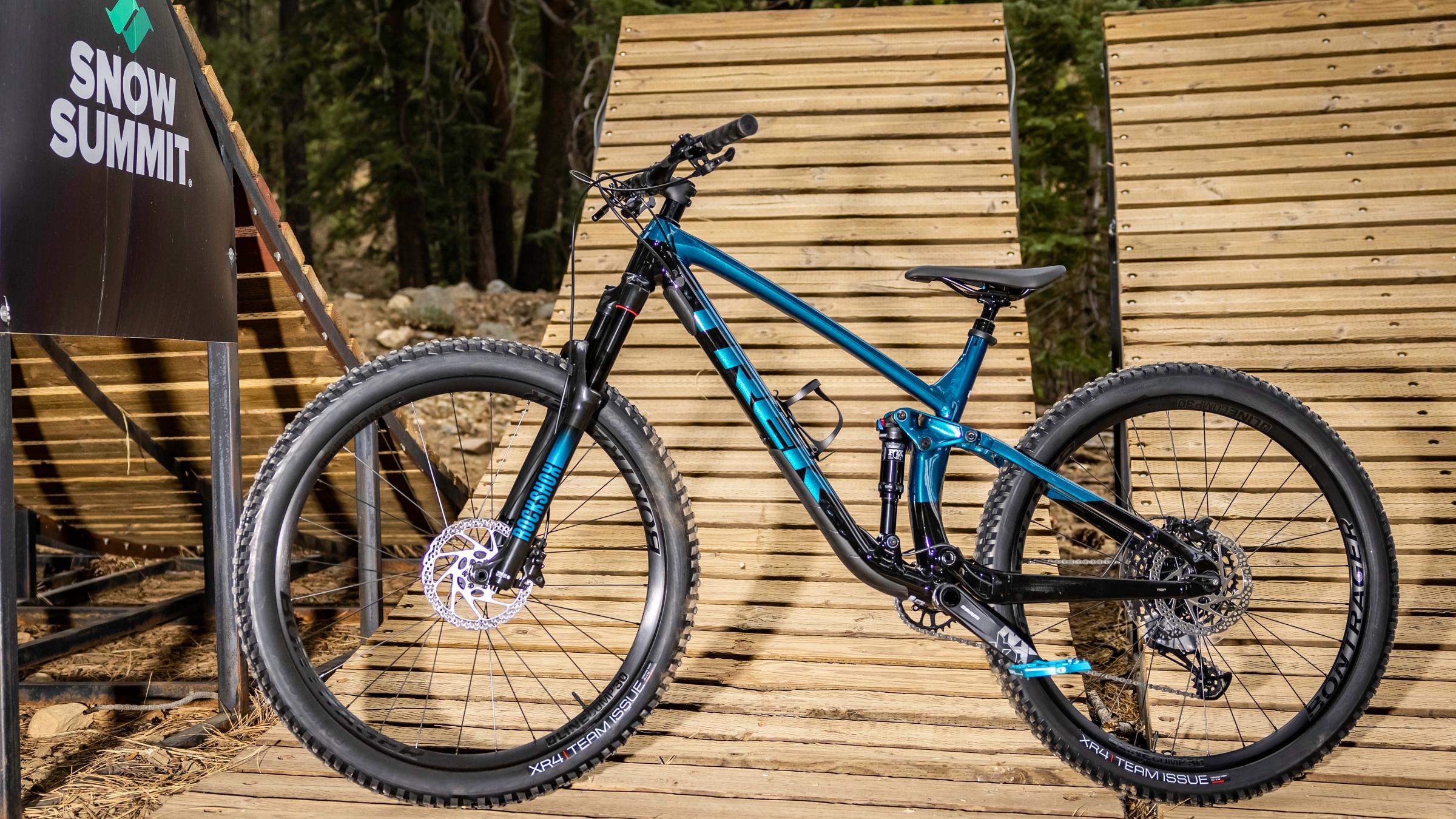Blue mountain bike sitting on a wooden ramp