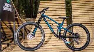 Blue mountain bike sitting on a wooden ramp