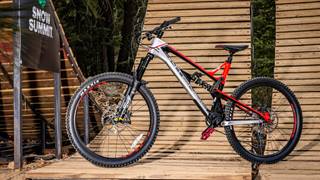 Red & silver mountain bike sitting on a wooden ramp
