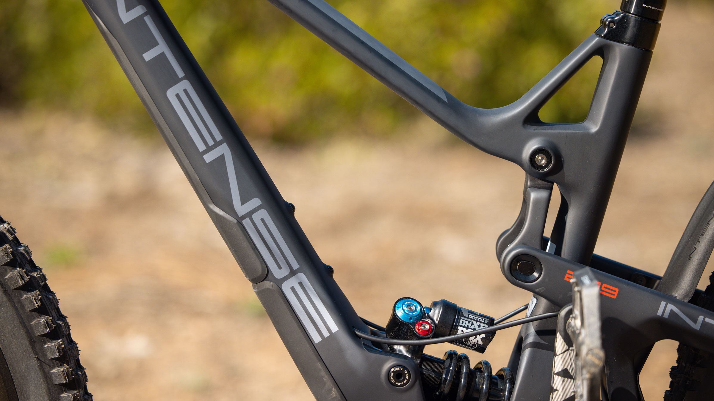 Close up of a mountain bike frame, grey bike with intense branding