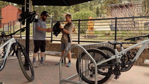 Mountain bike rentals at Snow Summit, technician helping rider get his bike ready