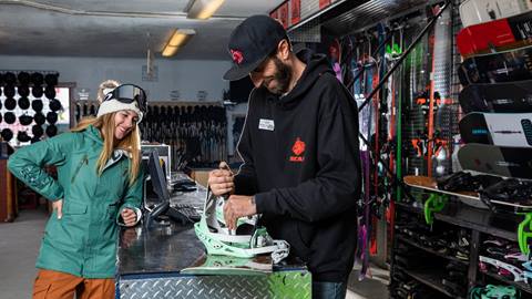 Woman renting a snowboard