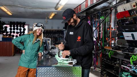 Girl getting her snowboard repaired