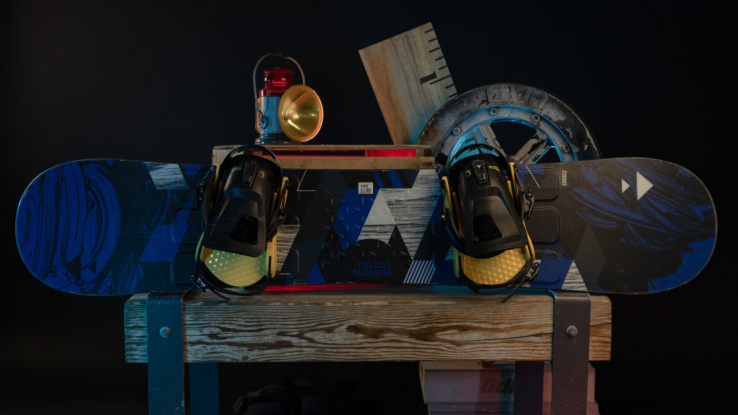 Snowboard and bindings displayed on a wooden box