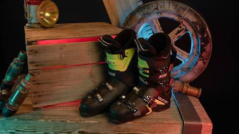 Ski boots displayed against wooden box