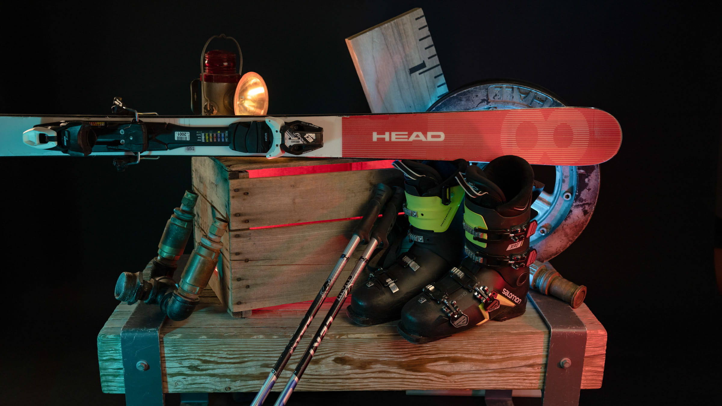 Ski boots, poles, and skis displayed upon a wooden box