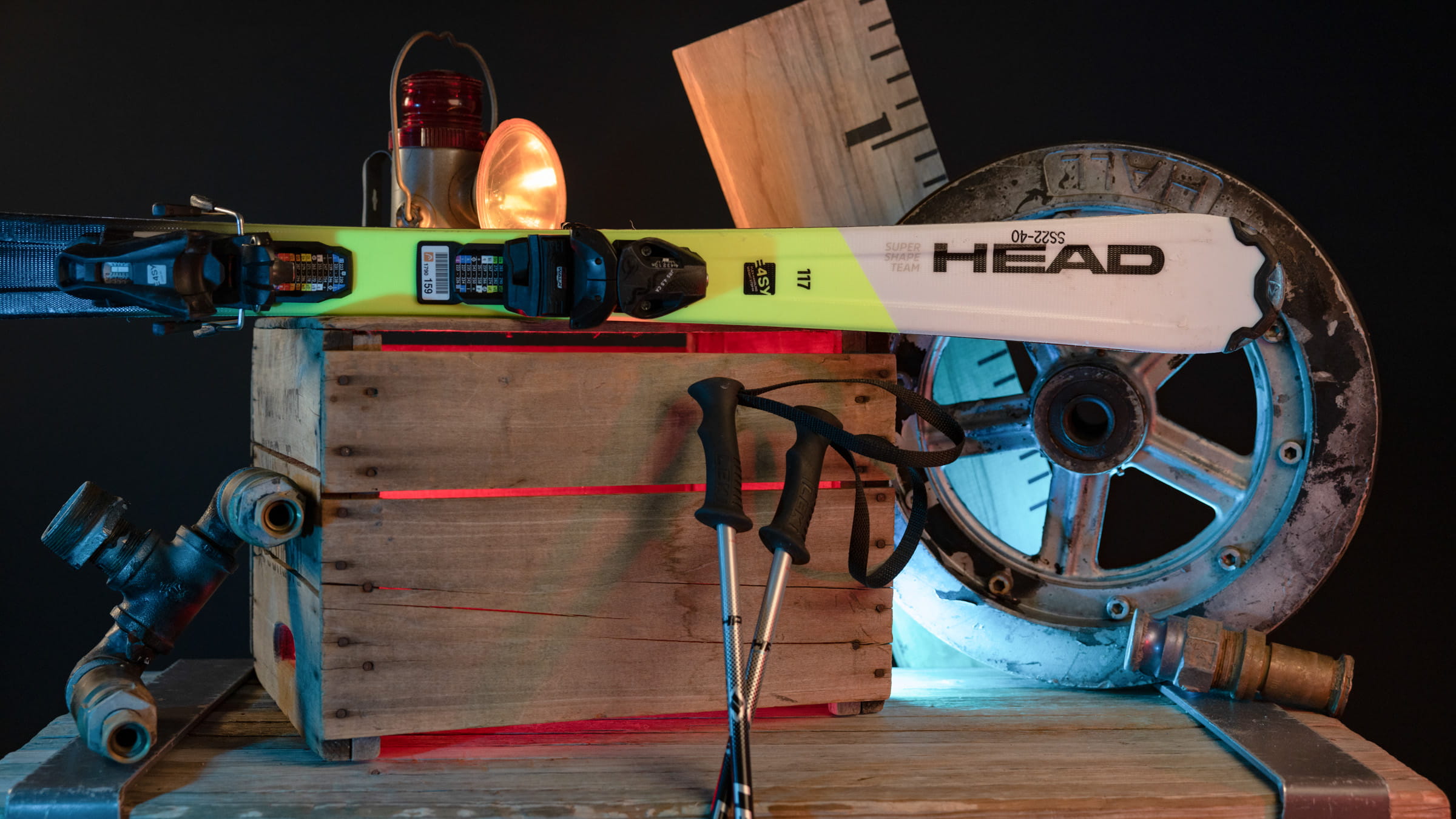 Skis and poles displayed upon a wooden box