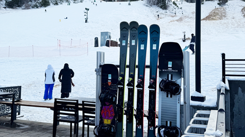 Rack of skis with snow in the background