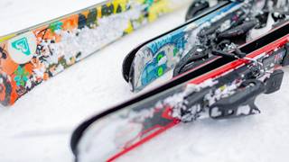 Skis laying on the snow.